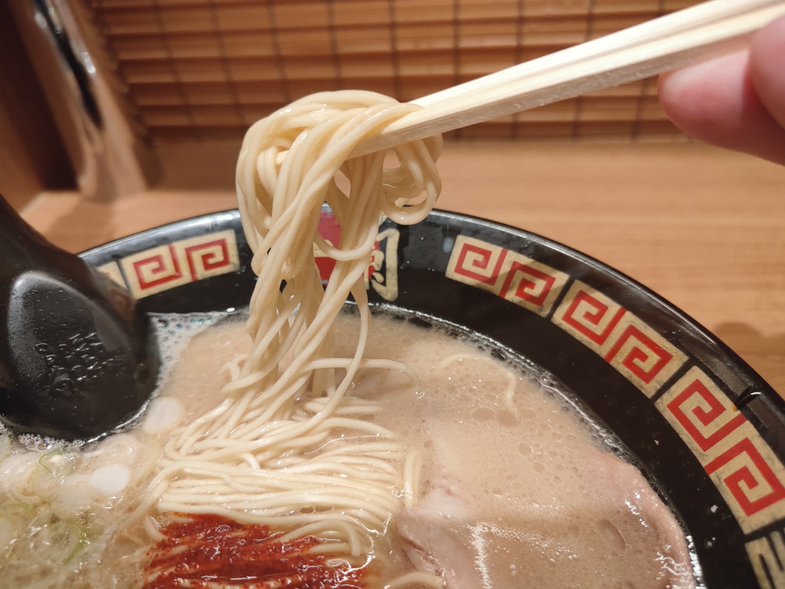 一蘭のラーメンの細麺を箸で持ち上げた写真